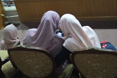 High angle view of people sitting on table