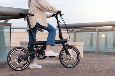 Zero emission concept. cropped woman legs riding an electric bicycle around the city 