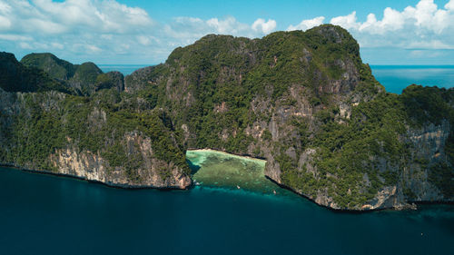 Scenic view of sea and mountains against sky