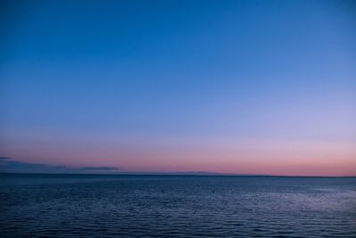 Scenic view of sea against clear sky during sunset