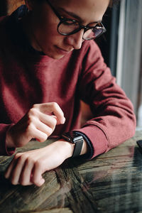 Woman checking time at table