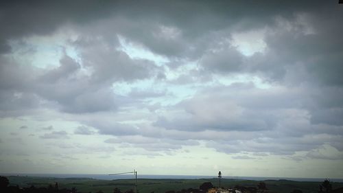 Scenic view of storm clouds over landscape against sky