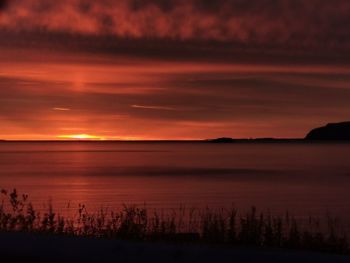 Scenic view of lake against romantic sky at sunset