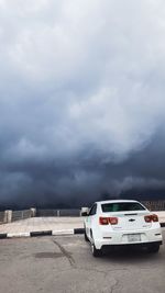 Car on road against cloudy sky