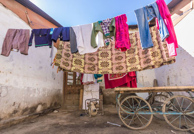 Clothes drying on clothesline against built structure