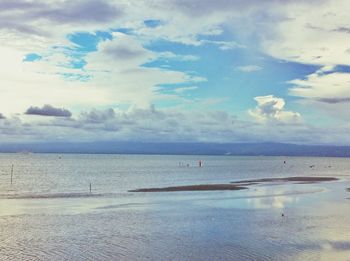 Scenic view of sea against cloudy sky