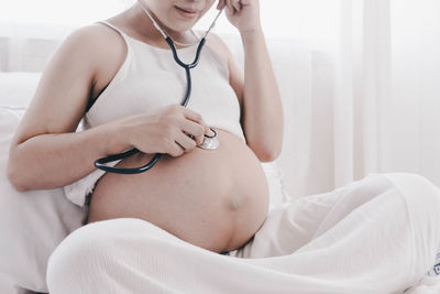 Midsection of woman holding hands