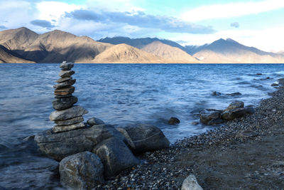 Scenic view of sea and mountains against sky