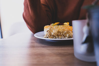 Close-up of man sitting on table