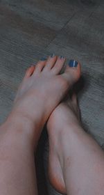 Low section of woman feet on floor