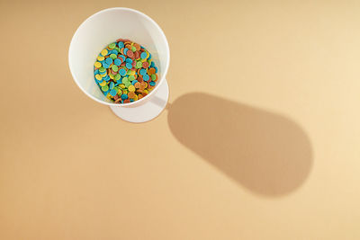 High angle view of food in bowl against yellow background