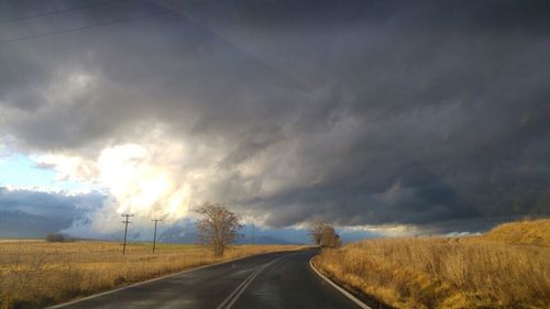 Country road passing through field