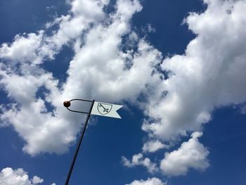 Low angle view of information sign against cloudy sky