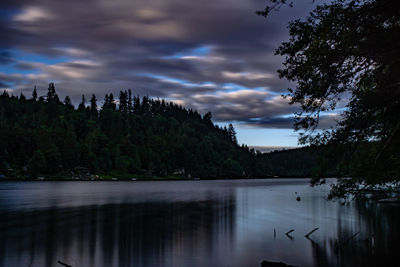 Scenic view of lake against sky at dusk