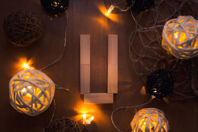 Directly above shot of letter u blocks and illuminated lights on wooden table