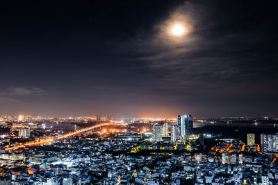 High angle view of illuminated city buildings at night