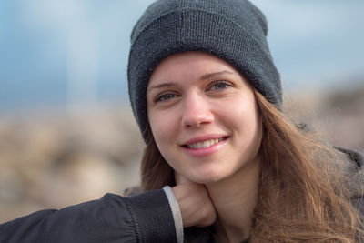 Portrait of smiling young woman wearing knit hat