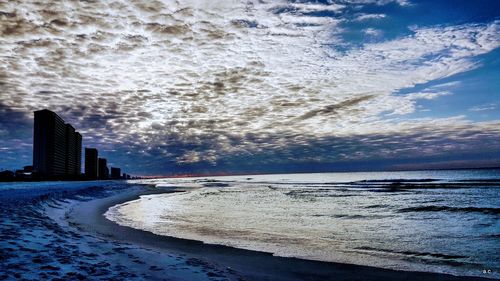 View of beach against cloudy sky