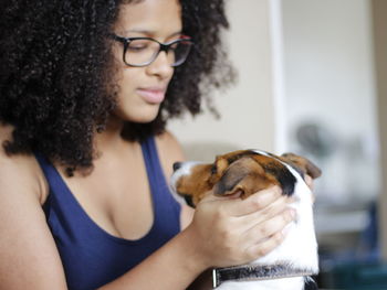 Close-up of young man holding dog