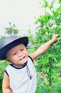 Portrait of smiling boy against plants