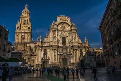 People at murcia cathedral against sky