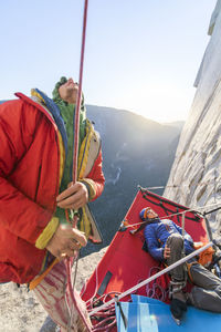 Two men looking up while climbing the nose on el capitan, yosemite