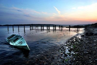Pier on sea at sunset