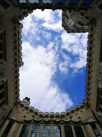 Low angle view of building against cloudy sky