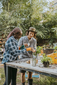 Young male and female farmers planting at farm