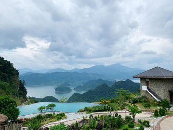 Scenic view of building and mountains against sky