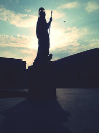 Low angle view of statue against cloudy sky