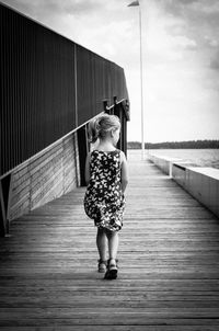 Full length of girl walking on pier