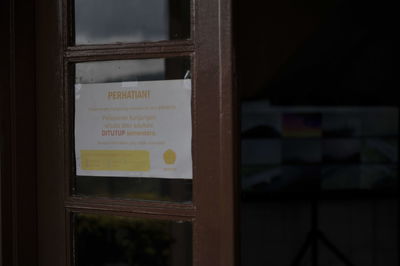 Close-up of text on glass window