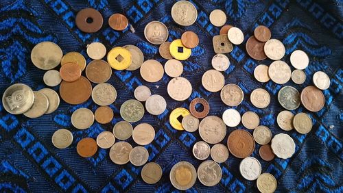 Directly above shot of various coins on textile