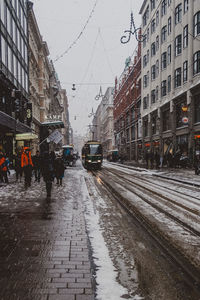 Wet street amidst buildings during rainy season