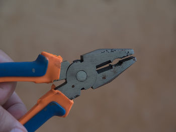 Close-up of hand holding pliers