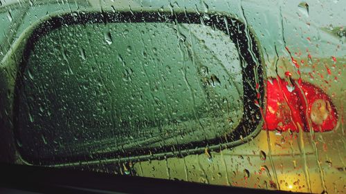 Close-up of water drops on car window