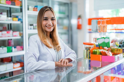 Portrait of young woman standing in store