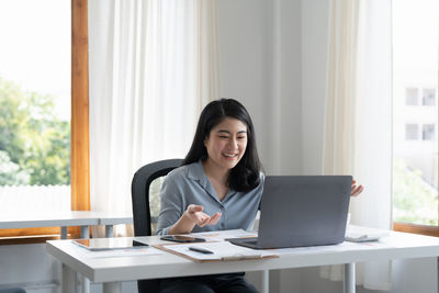 Businesswoman using laptop at office