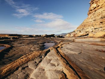 Rock formations on landscape against sky