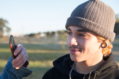 Portrait of young man wearing hat outdoors