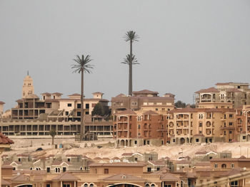 Houses in town against clear sky