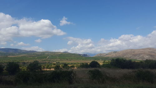 Scenic view of mountains against cloudy sky