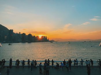 Group of people on beach at sunset