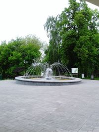 Fountain in park against clear sky