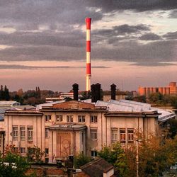 Buildings against cloudy sky