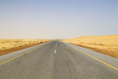 Road in desert against clear sky