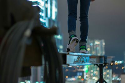 Low section of man standing metal at night