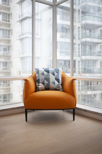 Chair by glass window at home