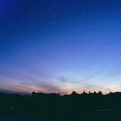 Low angle view of landscape against blue sky